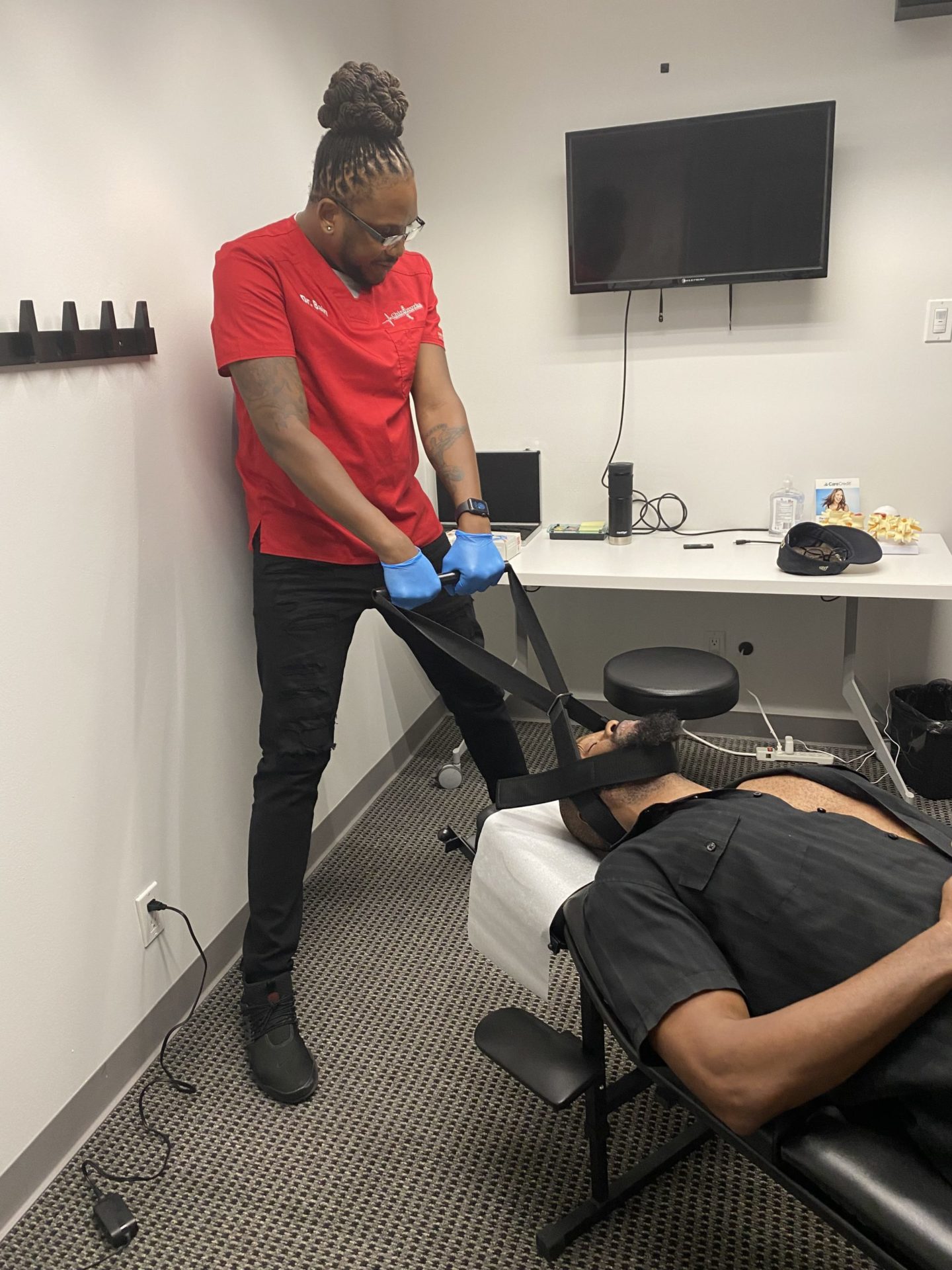 Dr. Bain adjusting client's neck
